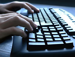 fingers typing on computer keyboard